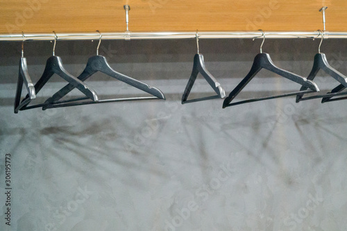clothes hangers hang on a metal bar © Olga