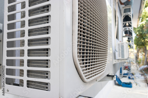 Air conditioner condenser unit standing outdoors
