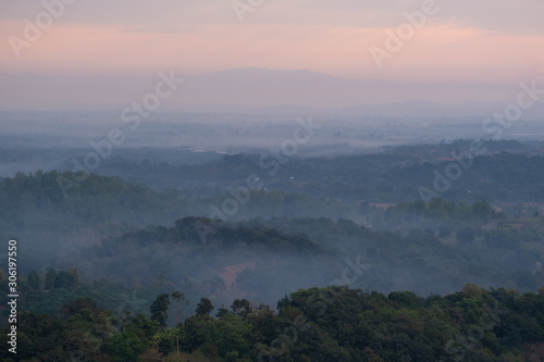 Mountain top view of local villages in northen Thailand during sunrise with fog