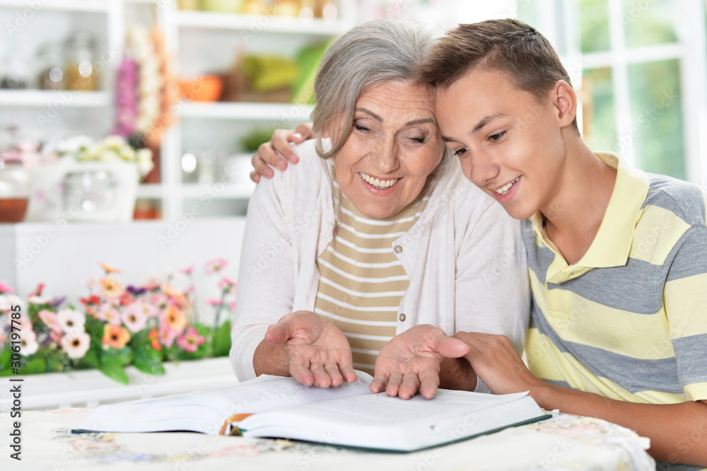 Portrait of grandmother and boy reading together at home Portrait of grandmother and boy reading together at home