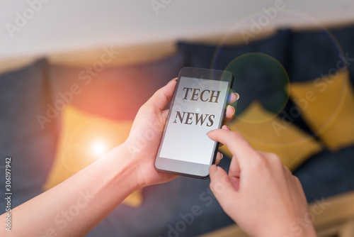 Word writing text Tech News. Business photo showcasing newly received or noteworthy information about technology woman using smartphone office supplies technological devices inside home