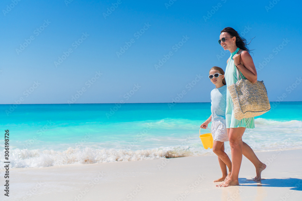 Beautiful mother and daughter on Caribbean beach