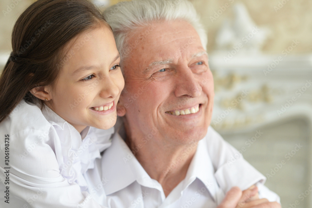 Portrait of happy elderly man with cute granddaughter Portrait of happy elderly man with cute granddaughter