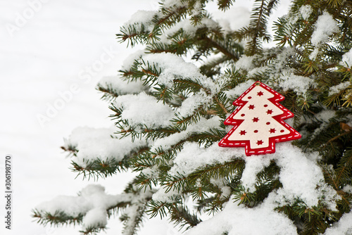 Christmas background with snow and christmas decoration on spruce branch (selective focus)/ Merry Christmas/ Happy New Year