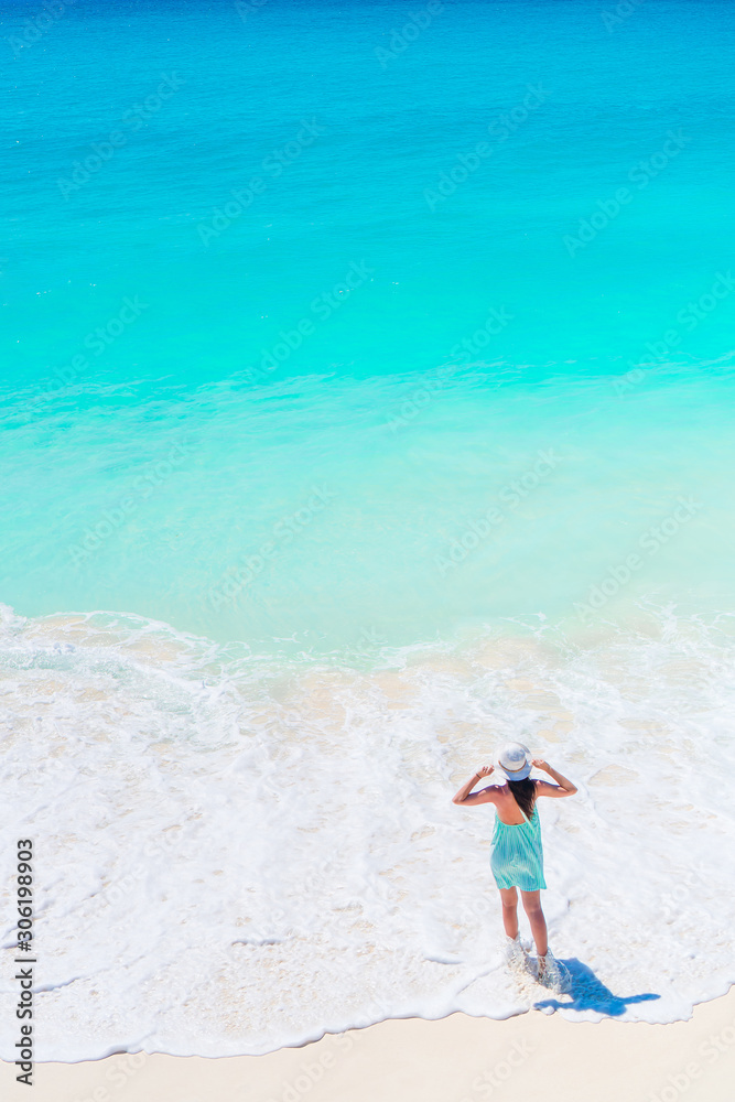 Young happy woman in swimsuit on white beach Young happy woman in swimsuit on white beach