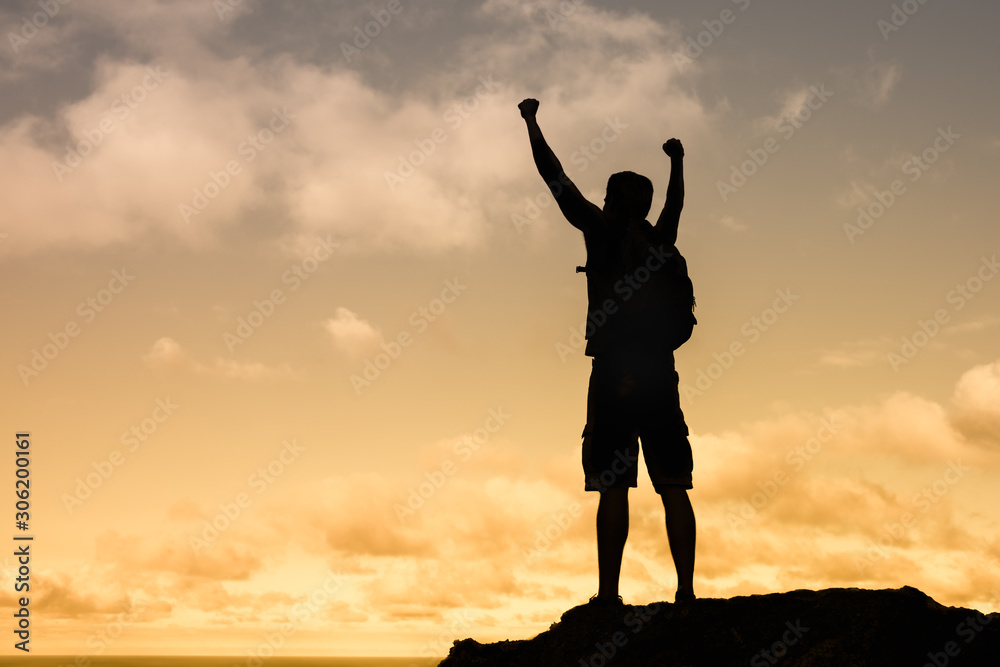 silhouette of a man on top of mountain. Challenging yourself concept. 