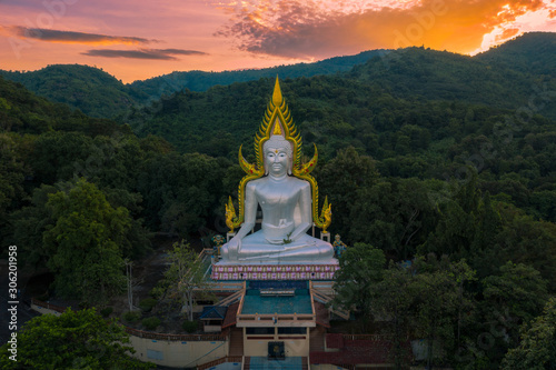 Thai temple on a mountain surrounded by trees and the sunset, Nakhon Nayok Province, Thailand