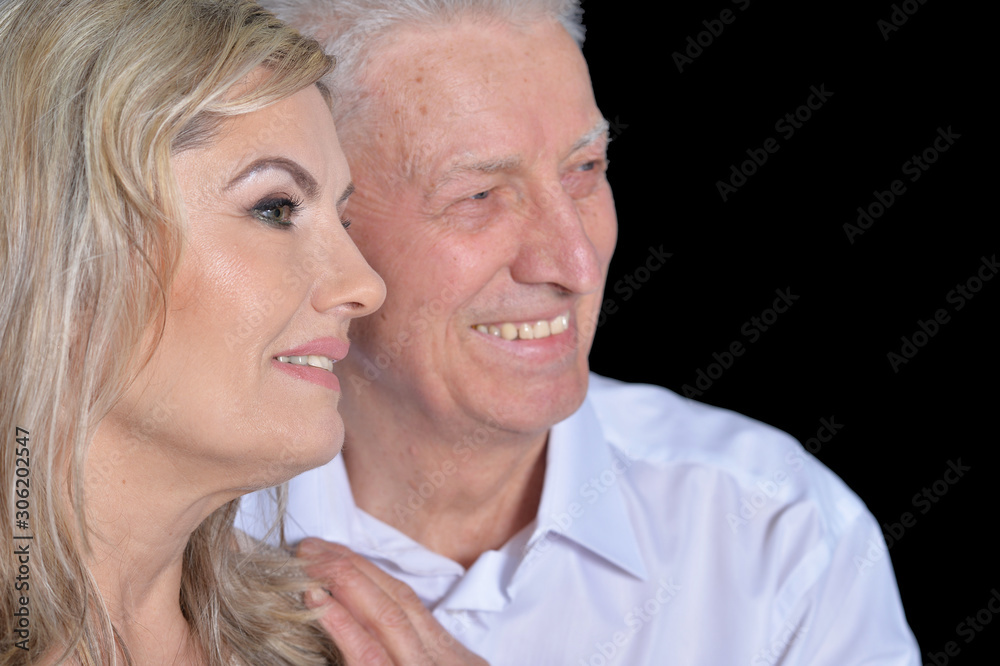Close up portrait of happy senior couple posing on black background Close up portrait of happy senior couple posing on black background