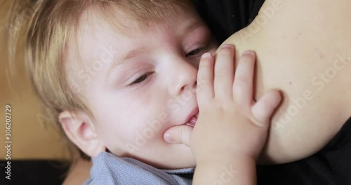 Mom breastfeeds a one-year-old baby