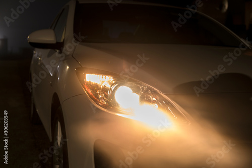 Dangerous Road Conditions. Night Time Driving in Fog. Abstract of car headlights in the fog.