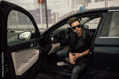  young fashionable man in glasses near the car © kalinichenkod