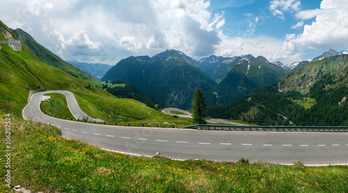Wide panorama view of nice mountain road over fantastic rocky mountains, Grossglockner Hochalpenstrasse pass. Alps. Summer day. copy space