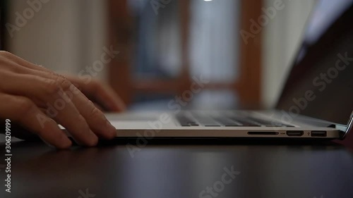 Man opens laptop in the office
