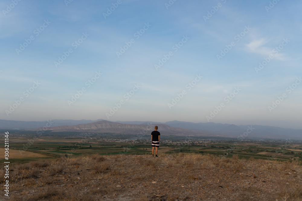 a man travels in Armenia, Yerevan. At sunset, she jumps silhouettes against the backdrop of Mount Ararat. Very beautiful landscape.