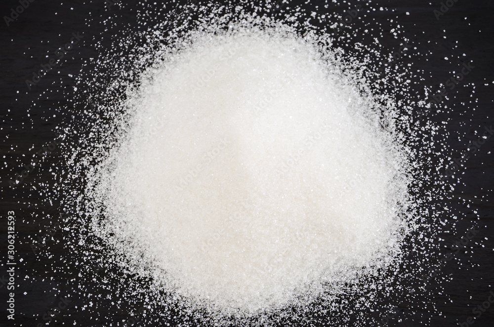 white sugar on a black background white sugar on a black background