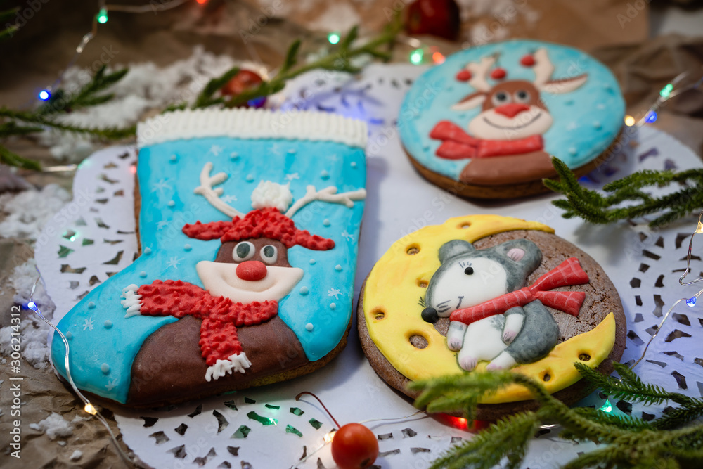 Assortment of Christmas cookies on openwork napkin. Round gingerbread cookies with deer and mouse. Christmas decor.