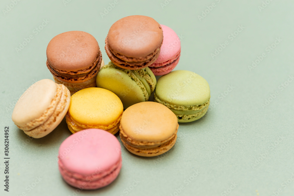 Colored tasty macaroons over a green background Colored tasty macaroons over a green background