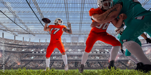 American football players in professional stadium.