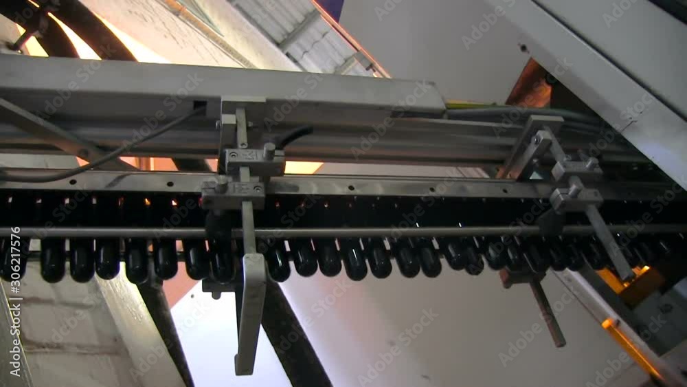 Plastic molding bottling factory. Special device escalator lift up plastic forms for pet bottle manufacture. Plastic recycling industrial factory. Blanks of plastic bottles in the factory. Plastic molding bottling factory. Special device escalator lift up plastic forms for pet bottle manufacture. Plastic recycling industrial factory. Blanks of plastic bottles in the factory.