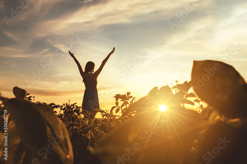 Girl summer field blue sundress enjoys sunset