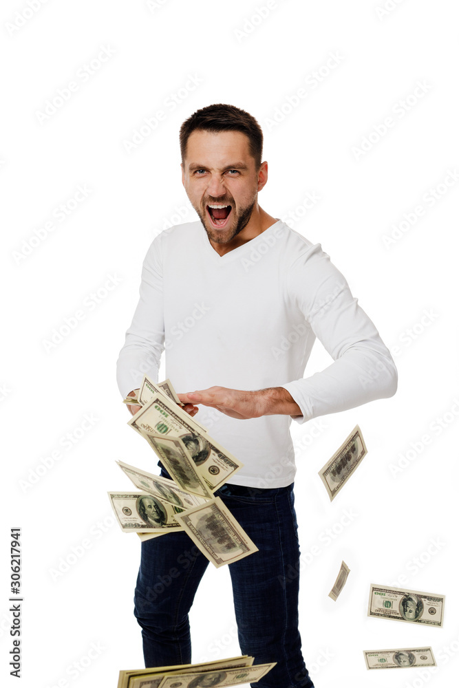 Naklejka premium young man throwing money banknotes at camera isolated on white background