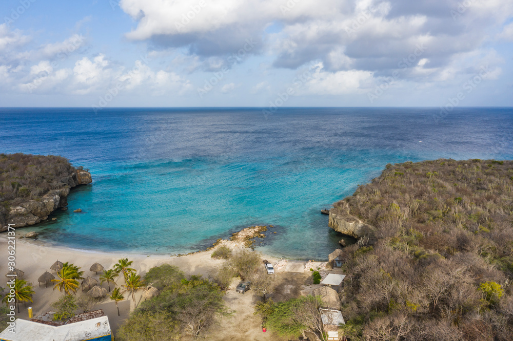 Aerial view of coast of Curaçao in the Caribbean Sea with turquoise water, cliff, beach and beautiful coral reef around Playa Daaibooi