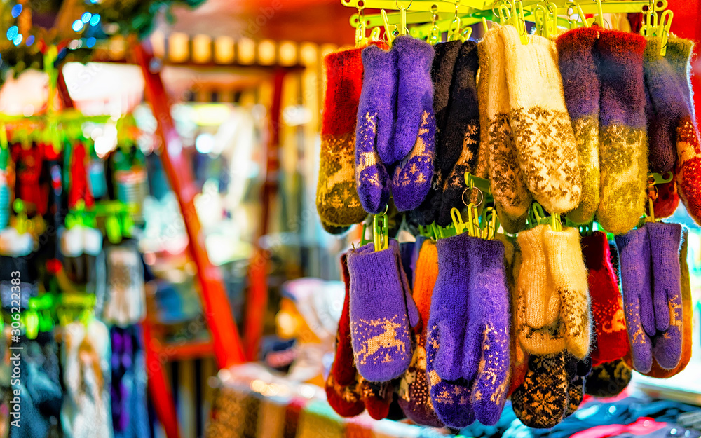 Colorful warm gloves at the Christmas Market in Riga, Latvia. Clothes. Wool mittens on stalls in winter. Street Xmas and holiday fair in European city or town. Advent Decoration with Crafts on Bazaar