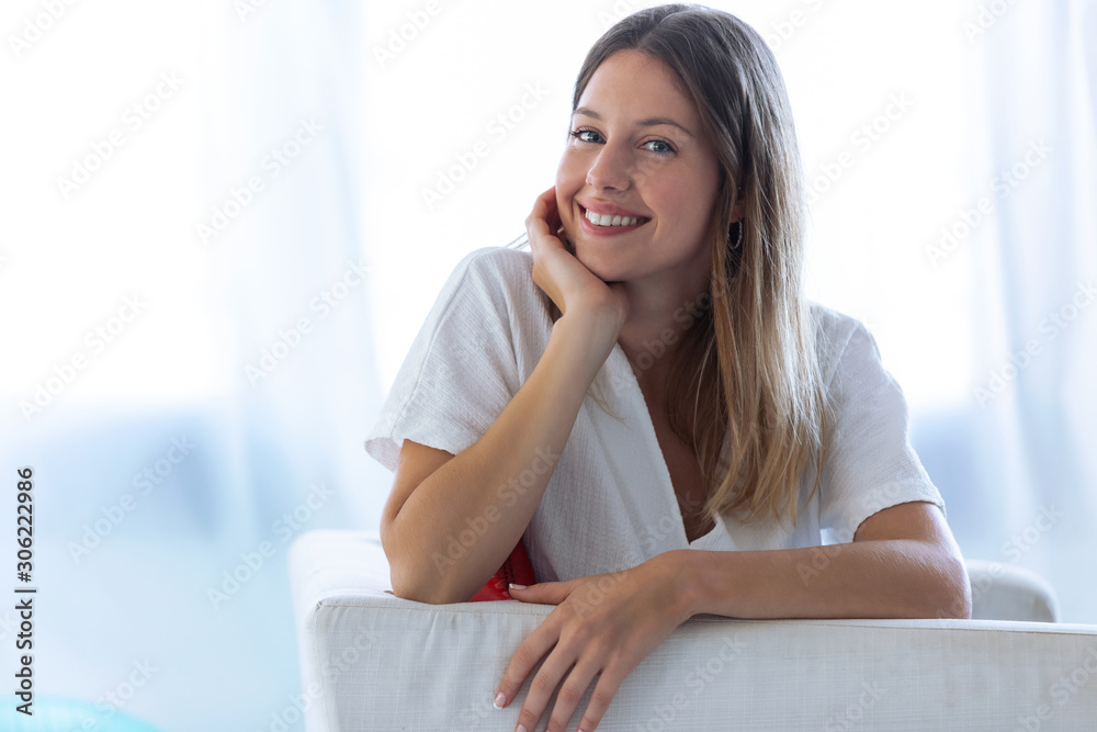 Happy young woman with perfect smile looking at camera at home. Happy young woman with perfect smile looking at camera at home.