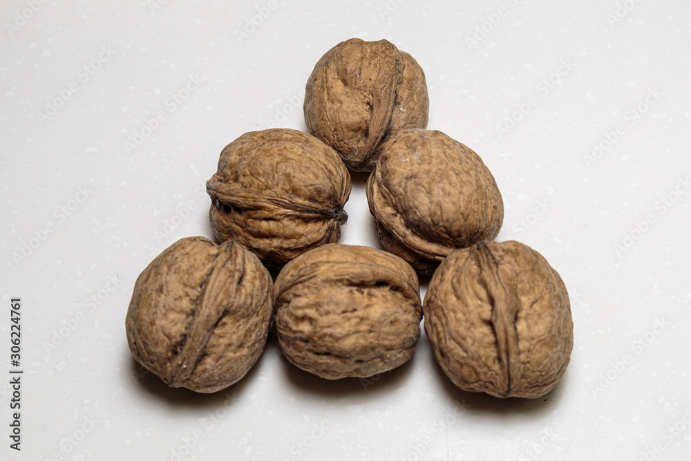 Walnut heap closeup. Vegan food. Concept of healthy food. Walnut heap closeup. Vegan food. Concept of healthy food.
