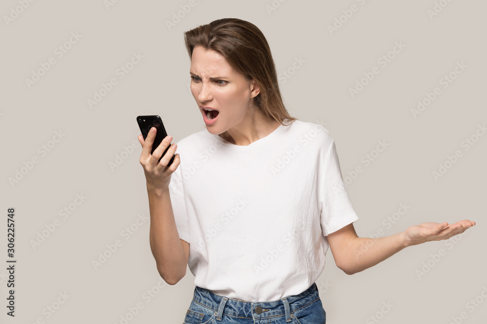 Angry woman screaming at phone, problem with broken cellphone Angry woman screaming at phone, problem with broken cellphone