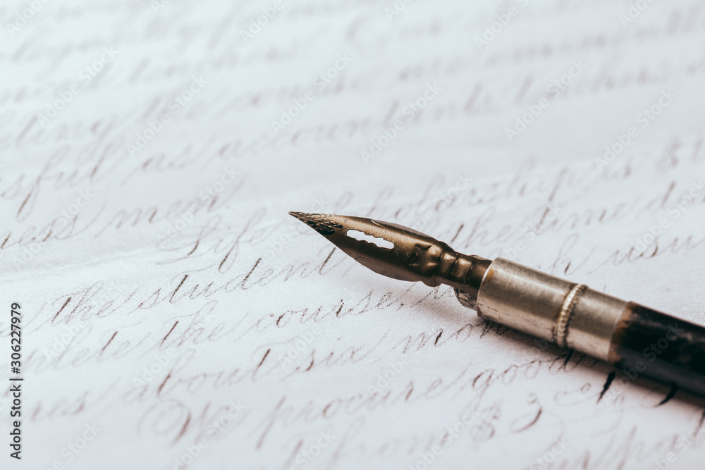 Fototapeta premium Fountain pen on an ancient handwritten letter. Old story. Retro style.