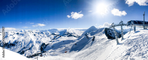 chairlift in front of switerland alps mountain range panorama with blue sky