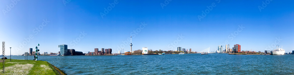 panoramic picture of rotterdam skyline at the port, blue sky