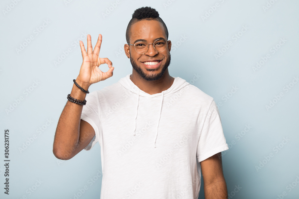 Happy smiling African American man, satisfied client showing ok gesture Happy smiling African American man, satisfied client showing ok gesture