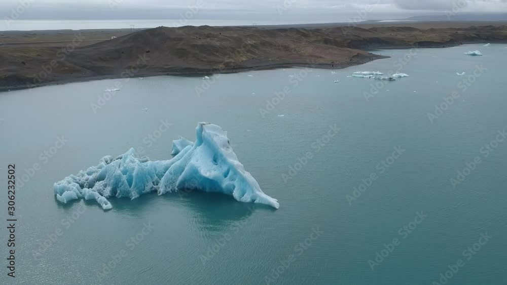 Aerial Fly over Glaciers Particles Floating In Glacial Lake Lagoon In Iceland. Jokulsarlon glacier lagoon, the deepest lake in Iceland. Aerial Fly over Glaciers Particles Floating In Glacial Lake Lagoon In Iceland. Jokulsarlon glacier lagoon, the deepest lake in Iceland.