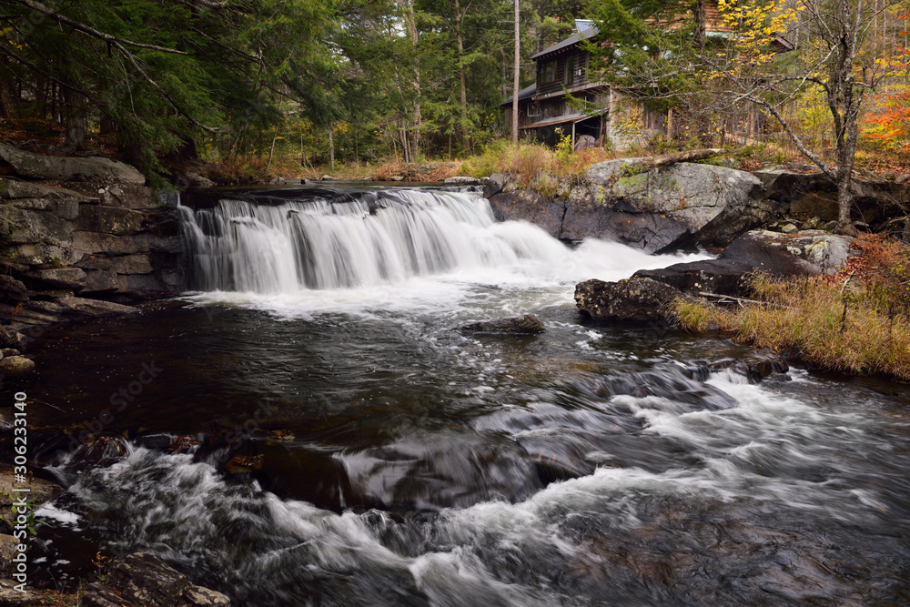 Fototapeta premium Homestead at falls on the Wells River West Groton Vermont in the Fall
