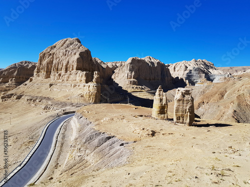 Ancient Tholing Monastery, Tibet. Ruins of ancient capital of Guge kingdom. Cave town inside a pyramid-shaped rock and a royal palace on the top. photo