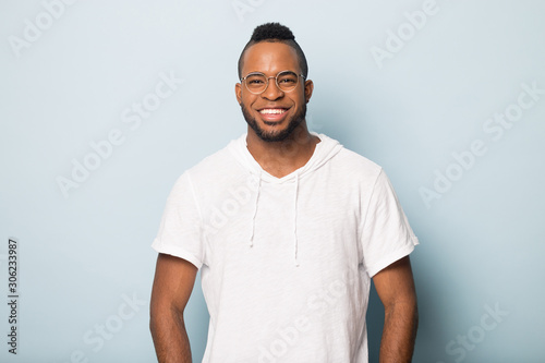 Smiling happy African American man in glasses looking at camera