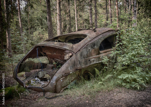 Rusty car in forest