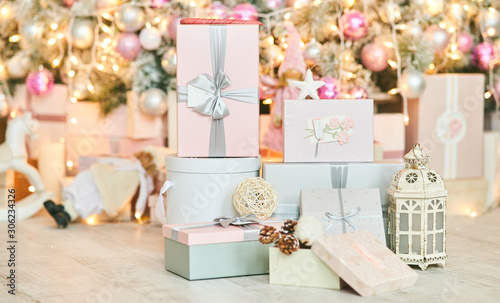 Christmas gift boxes on a background of a Christmas tree