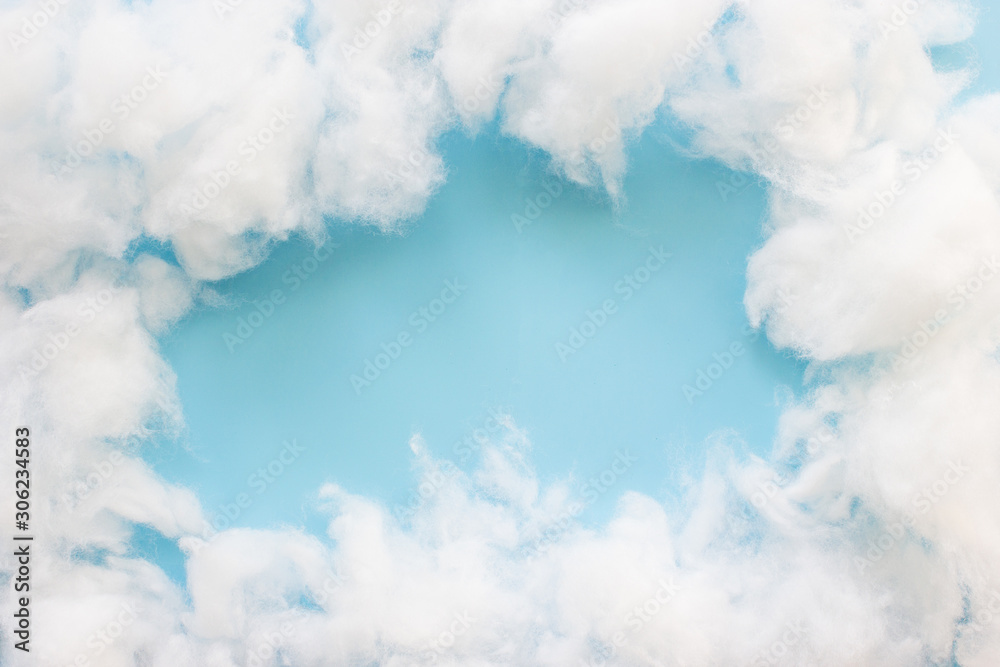 Frame a cotton wool clouds on light blue background. Concept clouds on