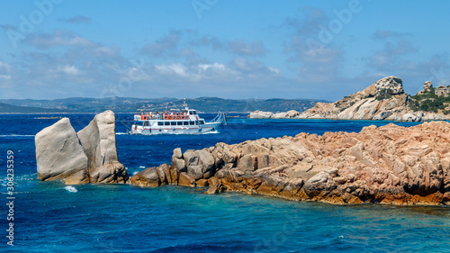 Foto Cruise boat with tourists in the sea near rocky coast of Sardinia, the Maddalena archipelago