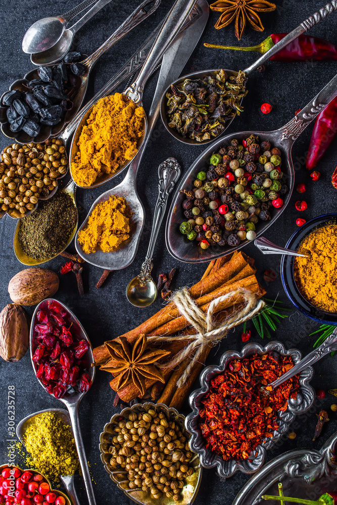 Naklejka Spices and herbs in metal bowls. Food and cuisine ingredients. Colorful natural additives.