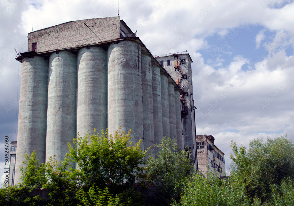The building of an old abandoned mill on a summer background. The building of an old abandoned mill on a summer background.