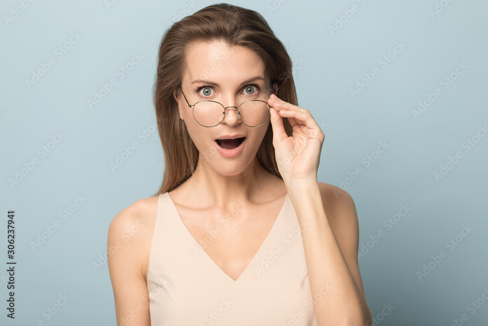 Surprised woman in disbelief taking off glasses, unexpected news Surprised woman in disbelief taking off glasses, unexpected news
