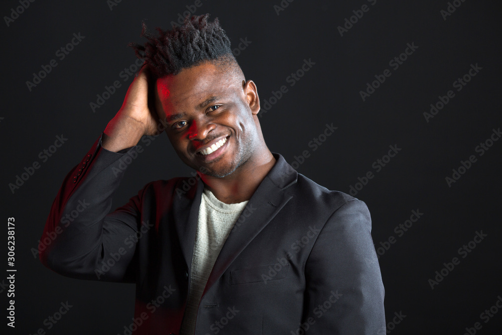 handsome african man in suit on black background