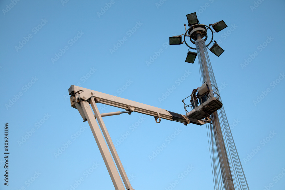 Crane and lighting pole in sunset Crane and lighting pole in sunset