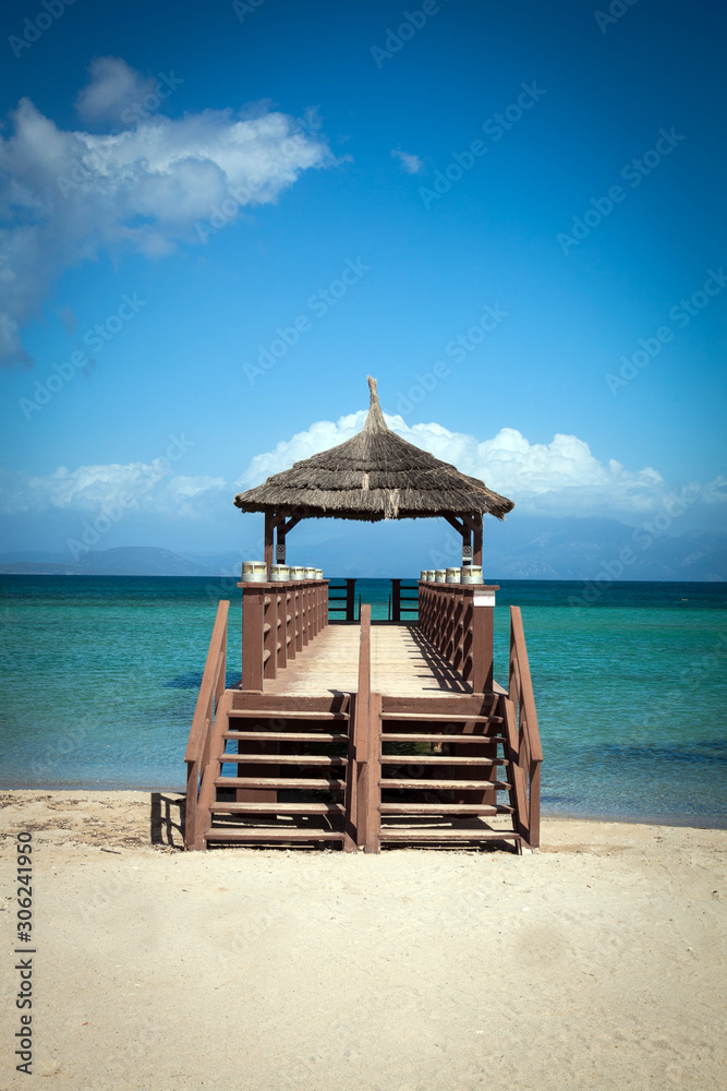 Tropical beach with wooden footbridge and summer holiday background