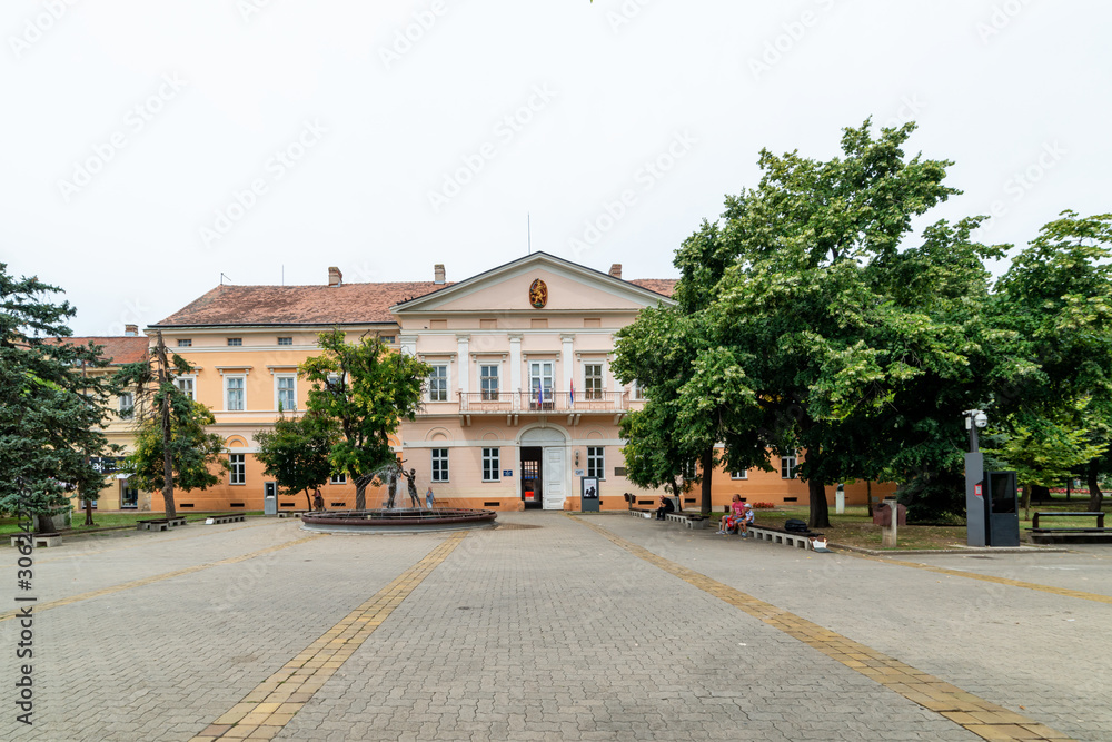 Kikinda, Serbia - July 26, 2019: National Museum building and beautiful fountain with sculpture 
