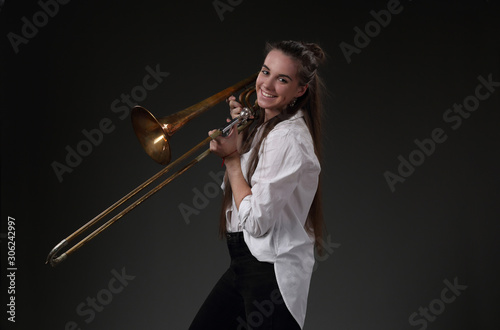 Portrait of smiling girl with trombone photo